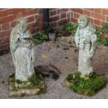 A pair of weathered concrete monk garden statues