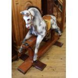 A 1950's grey rocking horse on oak frame stand