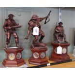 Three Danbury Mint collectable sculptures on wooden plinths holding various coins, The Liberator,