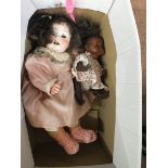 An Armand Marseille ethnic doll plus a porcelain doll marked 7