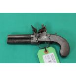 A Flintlock 'tap action' pistol with turnoff barrels, slab sided grips and slide safety,