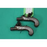 A pair of Flintlock pocket pistols, brass actions marked London, 5 1/4" overall with 1" barrels,