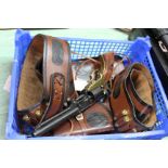 Two Western style leather holsters with inert rounds and a decorative Colt revolver