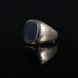 A gents signet ring set with onyx stone,