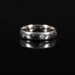 An 18ct white gold diamond set band ring,