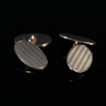 A pair of 9ct gold oval cufflinks with engine turned decoration