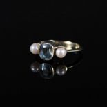 A yellow metal aquamarine and pearl set ring,