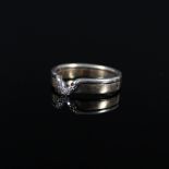 A two colour 9ct gold ring set with small diamonds (one missing),