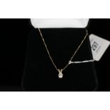 A solitaire white stone set pendant mounted in 14ct gold on 14ct gold chain