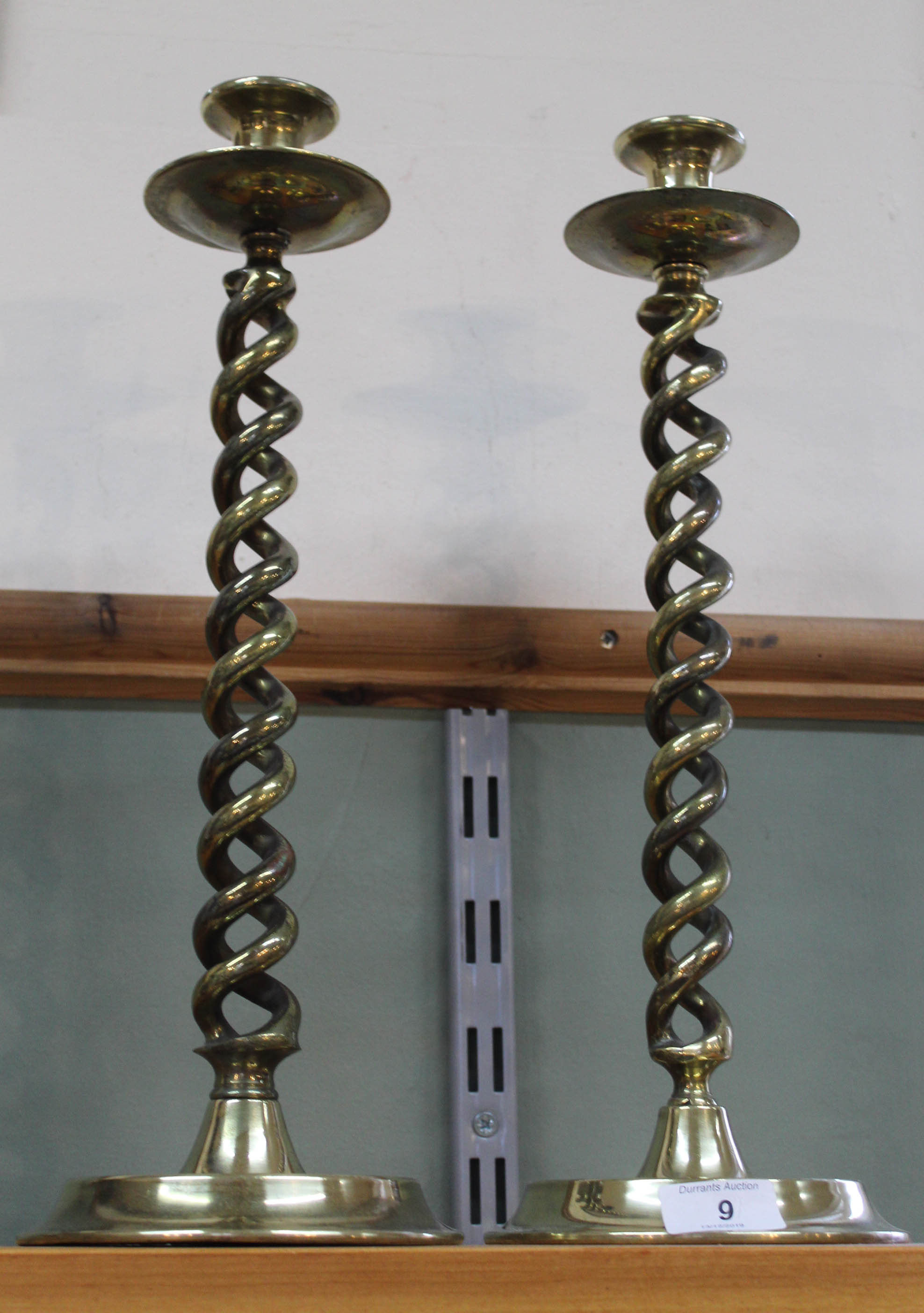 A large pair of late Victorian open barley twist brass candlesticks with drip trays and wide dished