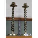 A large pair of late Victorian open barley twist brass candlesticks with drip trays and wide dished