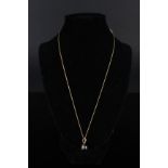 An 18ct gold black pearl and diamond pendant on 18ct gold chain