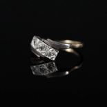 An 18ct platinum set Art Deco style three stone diamond ring,