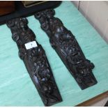 A pair of 18th Century carved oak pilasters with caryatid and lion mask decoration,