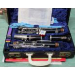 A cased Boosey & Hawkes clarinet plus music