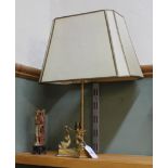 A Chinese gilt metal table lamp with soapstone figure and porpoise supports