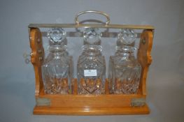 Three Bottle Tantalus with Silver Plated Mounts made by P.B & S