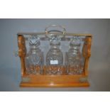 Three Bottle Tantalus with Silver Plated Mounts made by P.B & S