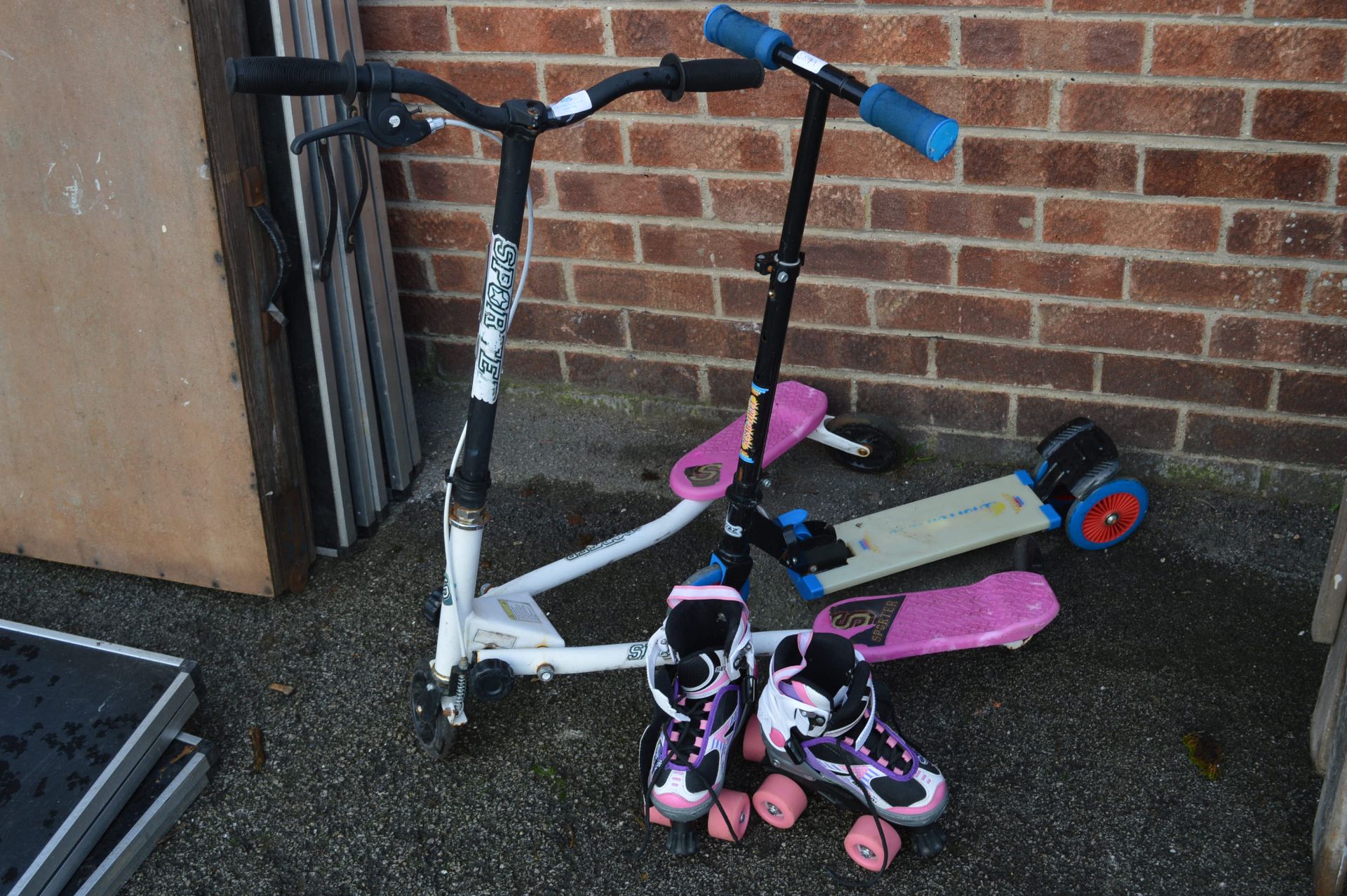 Two Girls Scooter and a Pair of Roller Skates