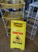 Two Racks and a Wet Floor Warning Sign