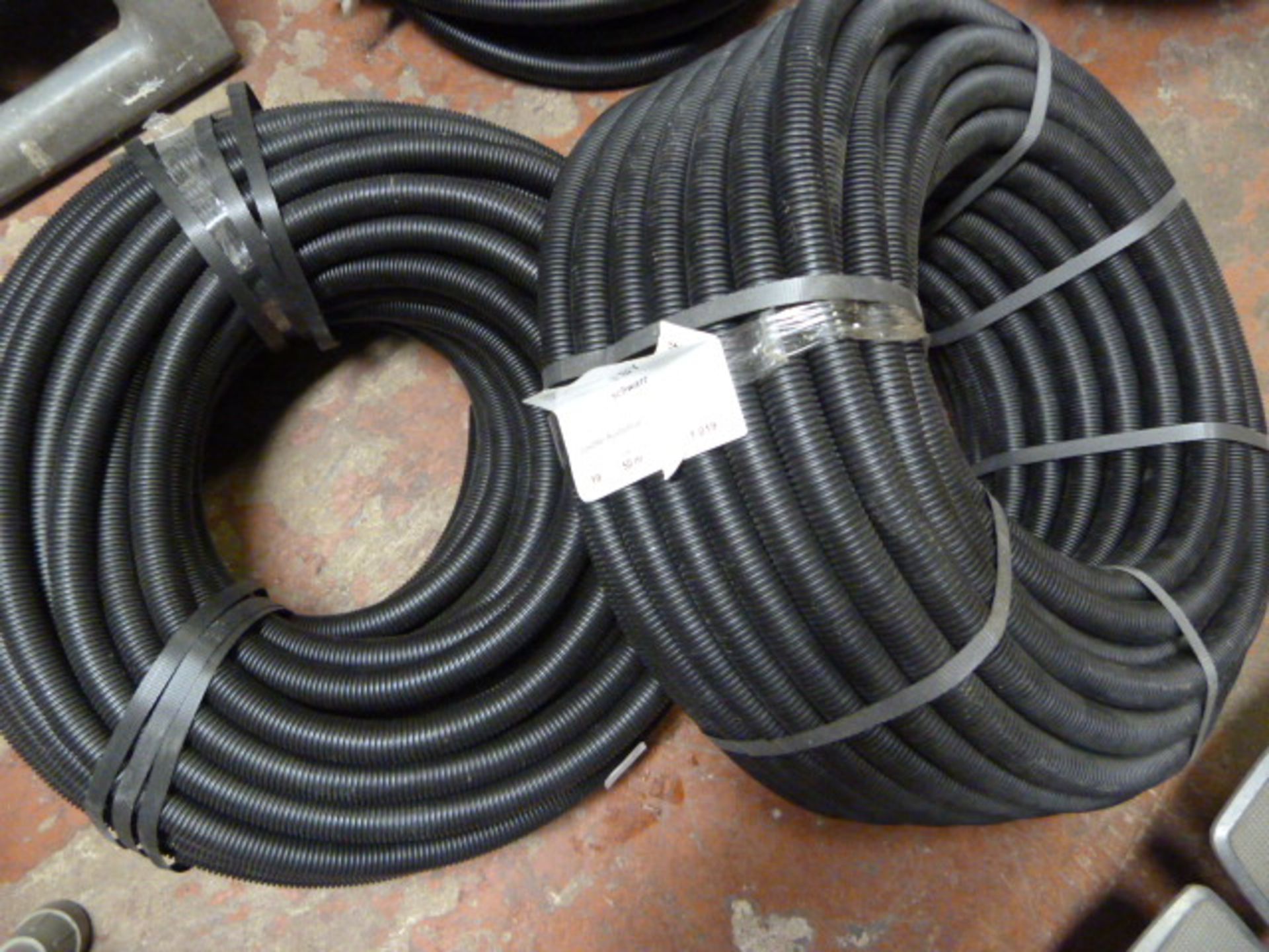 *Two Coils of Plastic Hose