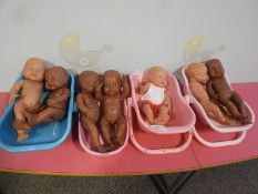 *4 Baby Seats Containing 7 Dolls