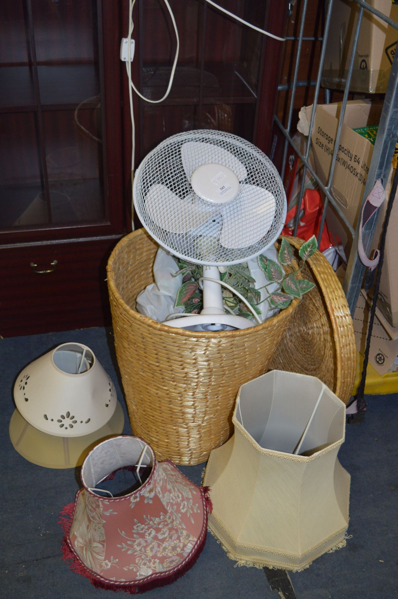 Desktop Fan and a Laundry Basket Containing Lampsh