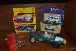 Four Boxed Model Cars and Model Racing Car