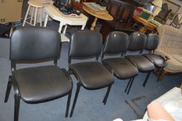 Five Black Vinyl Stacking Chairs