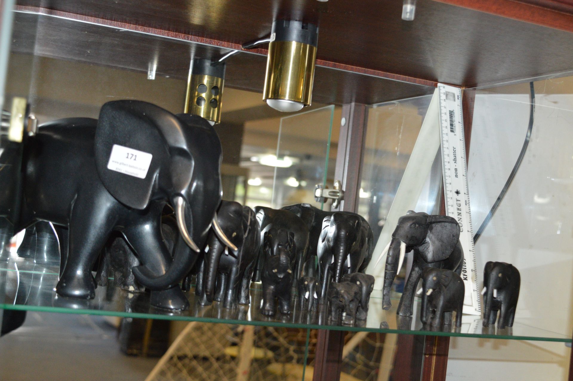 Twelve Small Carved Ebony Elephants and One Large