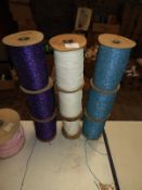 Three White and Three Blue Rolls of Glitter Thread