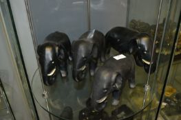 Four Black Pottery Elephants