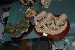 Three Decorative Elephant Figurines on Plinths