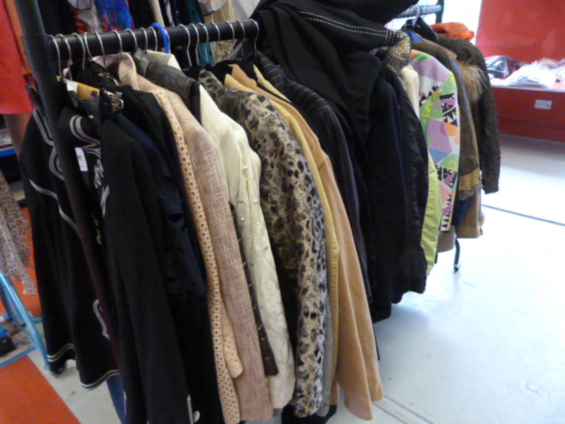 Rail of Assorted Jackets and Tops