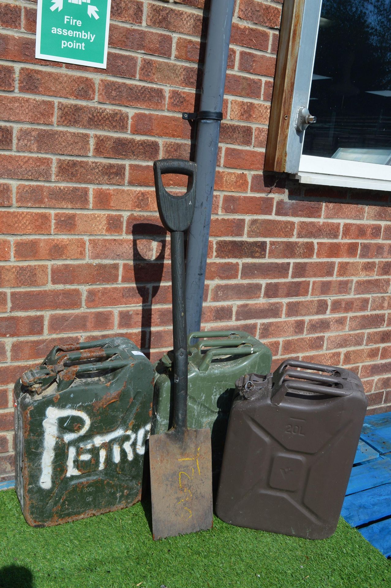 Three Army Petrol Cans and a Spade