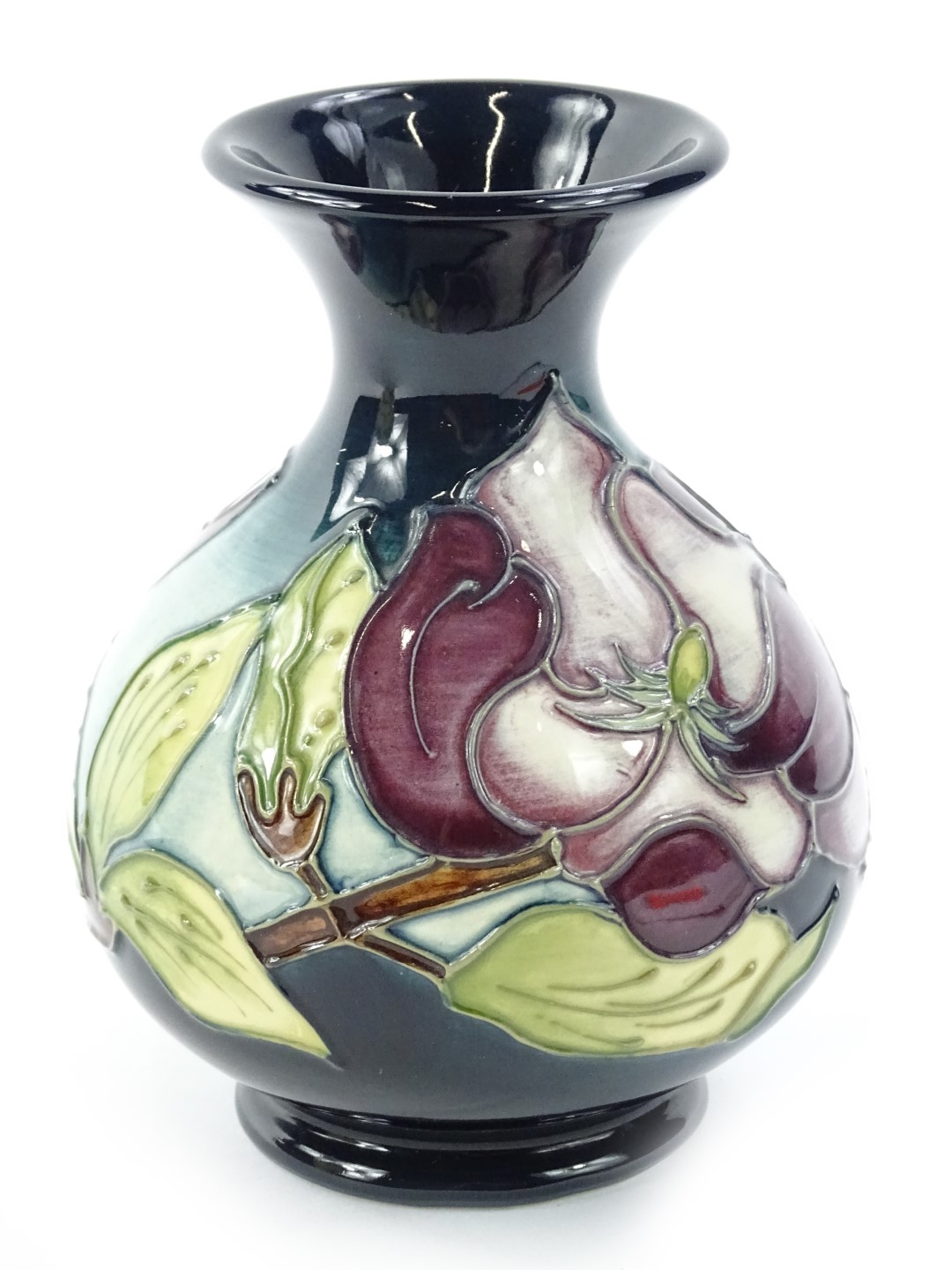 A Moorcroft Magnolia pattern vase, designed by Walter Moorcroft, the tube lining by Catherine