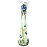 A MacIntyre & Co Moorcroft Florian ware vase, decorated with a poppy design, in blue and green, on a