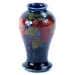 A Moorcroft Pomegranate pattern baluster vase, decorated with fruit, on a cobalt blue ground,