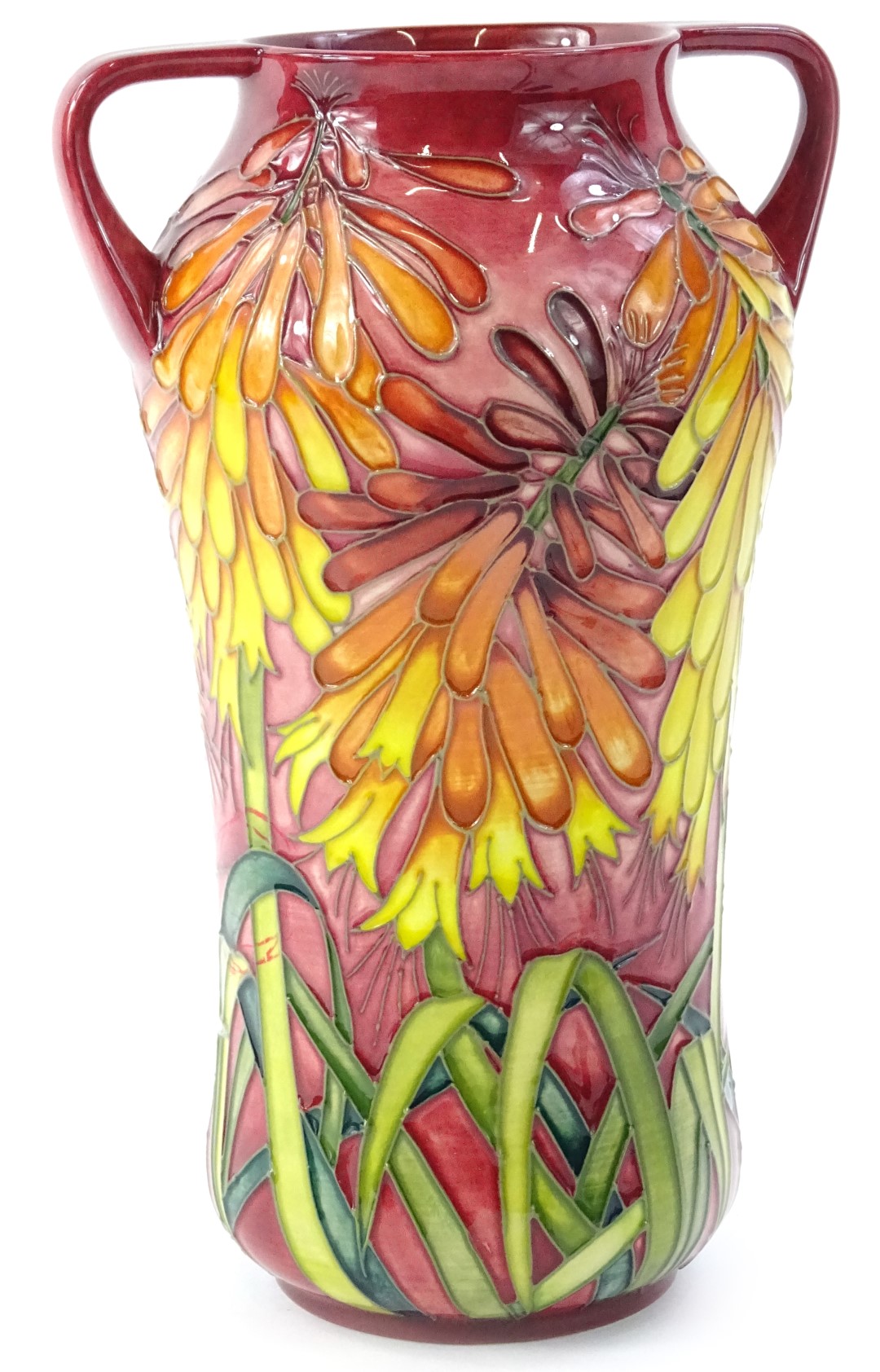 A Moorcroft two handled trial vase, decorated with brightly coloured orange, red, pink flowers, with