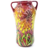 A Moorcroft two handled trial vase, decorated with brightly coloured orange, red, pink flowers, with