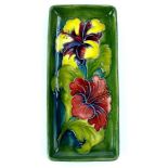 A Moorcroft Fuschia pattern rectangular tray, decorated with flowers on a green ground, impressed