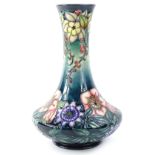 A Moorcroft Centenary year Carousel range bottle shaped vase, decorated with columbine, redcurrants,