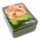 A Moorcroft Coral Hibiscus pattern small box and cover, designed by Walter Moorcroft, 9.5cm W.