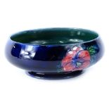 A William Moorcroft Pansy pattern shallow bowl, hand scripted mark and impressed potter to the