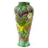 A Moorcroft trial vase, decorated with orchids and exotic flowers on a green ground, signed Philip