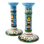 A pair of Moorcroft tribal range candlesticks, designed by Jackie Rowe, with tube lining by Kerry