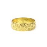 An 18ct gold wedding band, with star design, 3.4g.