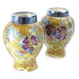 A pair of MacIntyre miniature vases, each decorated with flowers within raised gilt leafy borders,