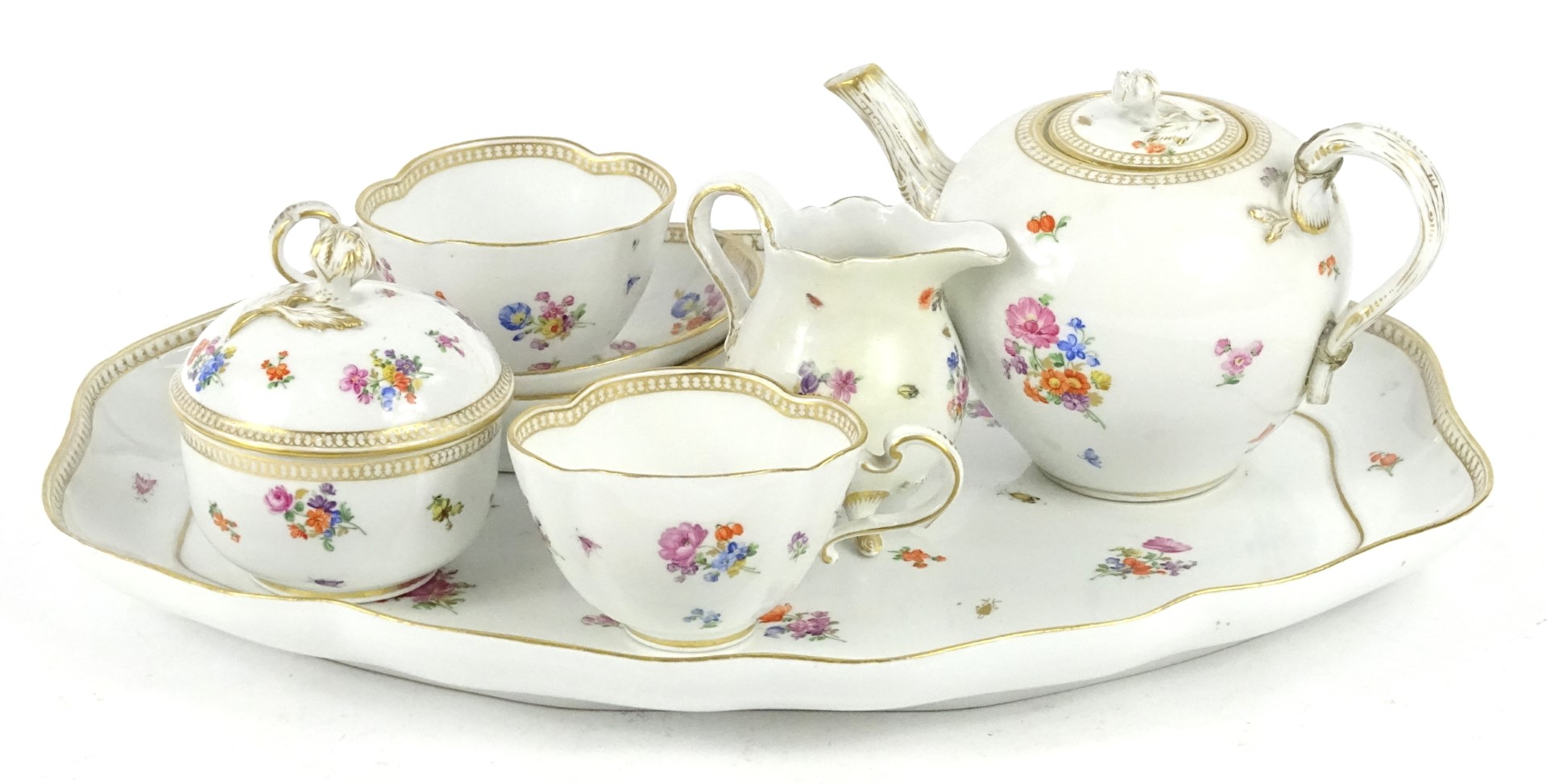 A late 19th/early 20thC Meissen porcelain cabaret tea set, each piece decorated with flower