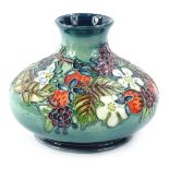 A Moorcroft centenary year carousel range vase, decorated with wild strawberry and blackberry,